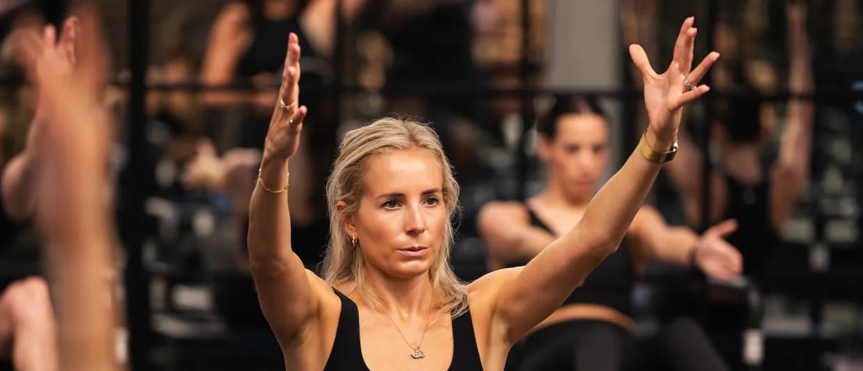 Woman leading a group Transformer Pilates class at KARVE Studio